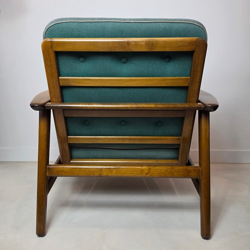 Back of an authentic Hans Wegner GE233 easy chair with original multicoloured striped box cushions, sculpted solid timber frame, and classic Danish Modern design