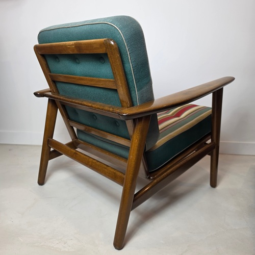 Mid‑century Wegner GE233 armchair produced by Getama, featuring rare original box cushions in striped fabric and a warm, rounded timber frame