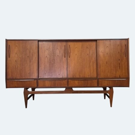 Authentic mid‑century Danish teak sideboard with four sliding doors, carved recessed handles, four lower drawers, and a sculptural tapered‑leg stretcher base