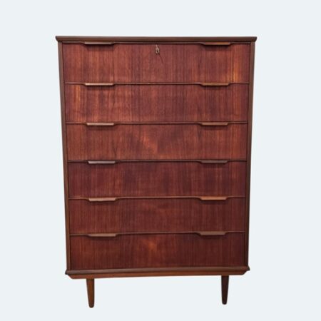 Front view of Danish mid‑century teak dresser showing veneered teak and sculpted handles