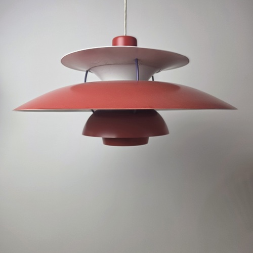 Louis Poulsen PH 5 pendant lamp in red, showcasing the sculptural layered shade system and glare-free lighting design