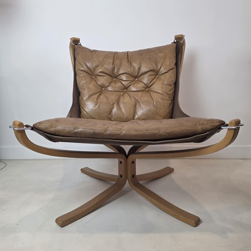 Vintage Sigurd Ressel Falcon chair styled in a Scandinavian interior with patinated leather and beech frame.